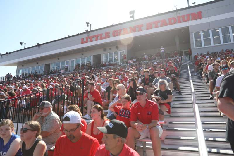 a crowd of people sitting in bleachers