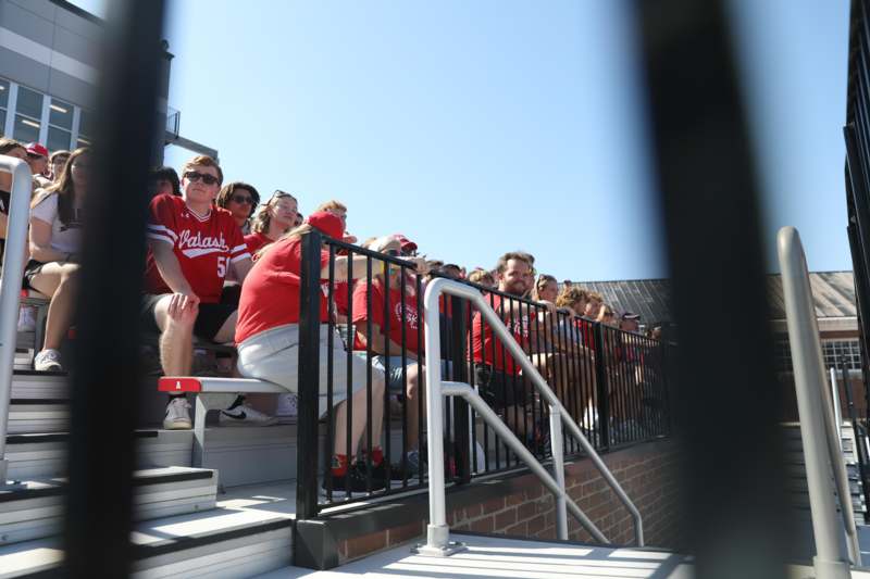 a group of people sitting on bleachers
