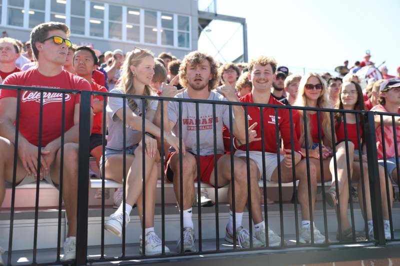 a group of people sitting on bleachers