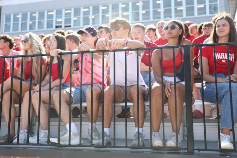 a group of people sitting on bleachers