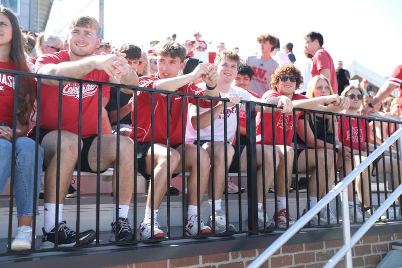 a group of people sitting on a railing