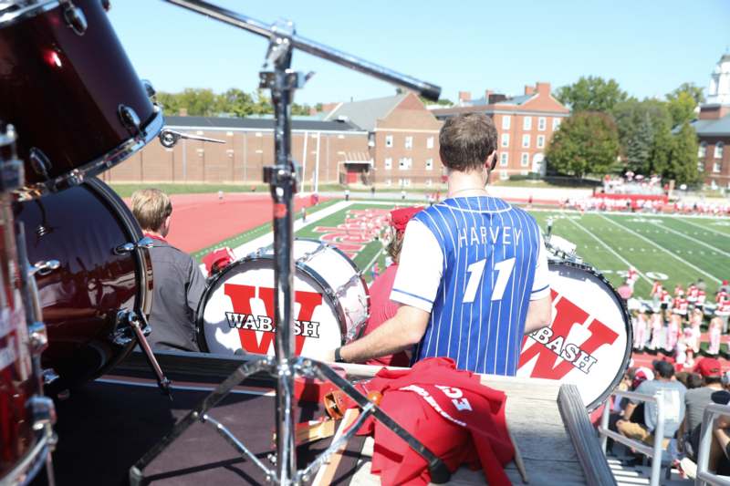 a group of people playing drums on a football field