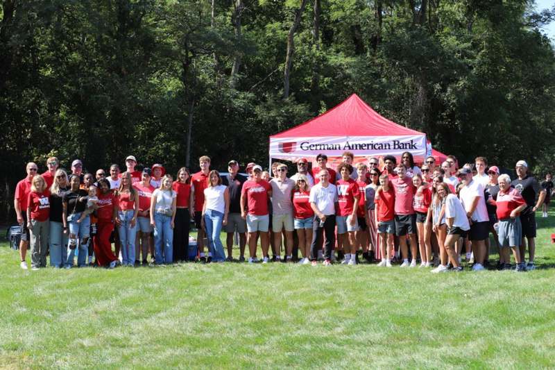 a group of people standing in front of a tent