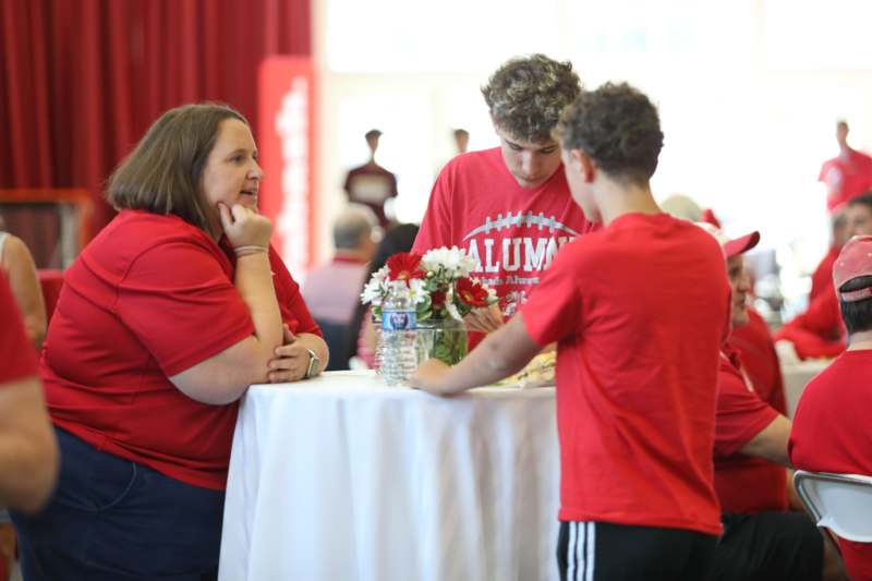 a group of people standing around a table