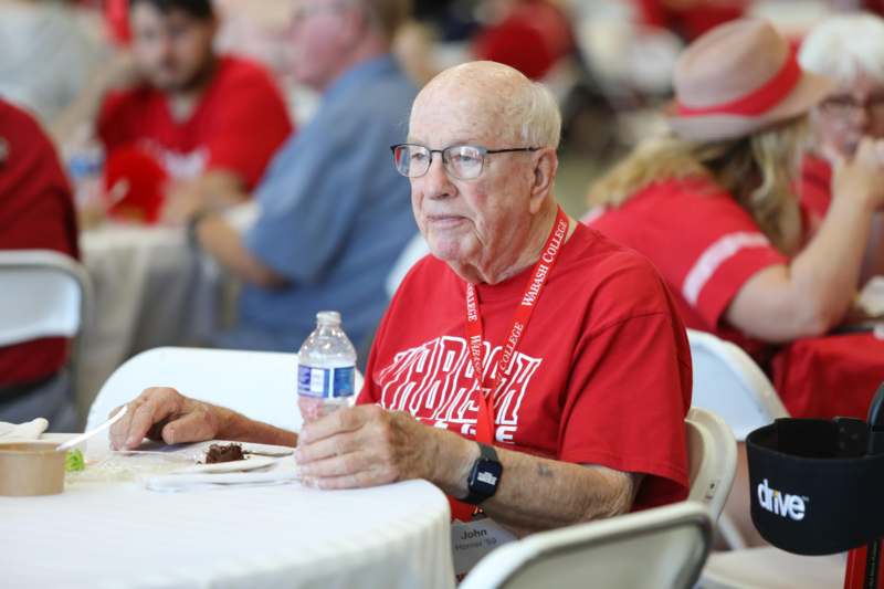 an old man sitting at a table
