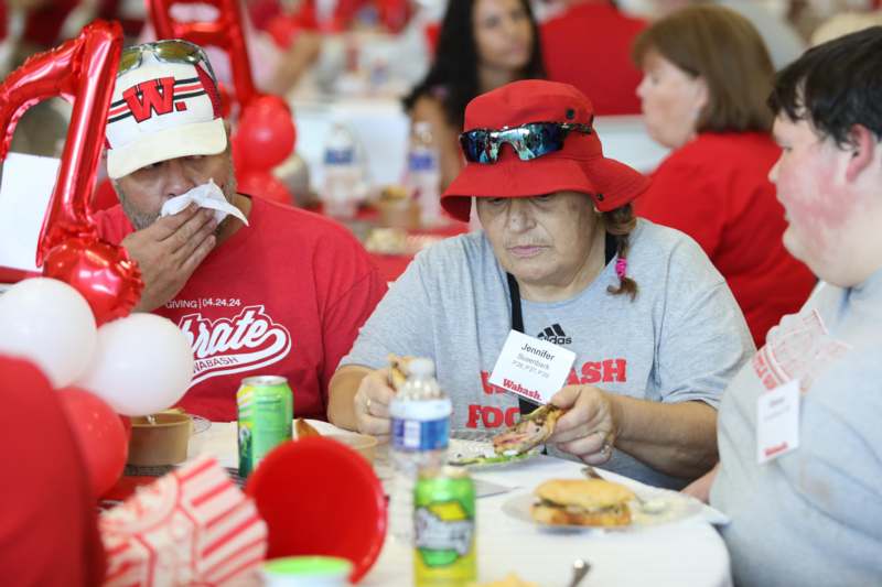 a group of people sitting at a table eating food