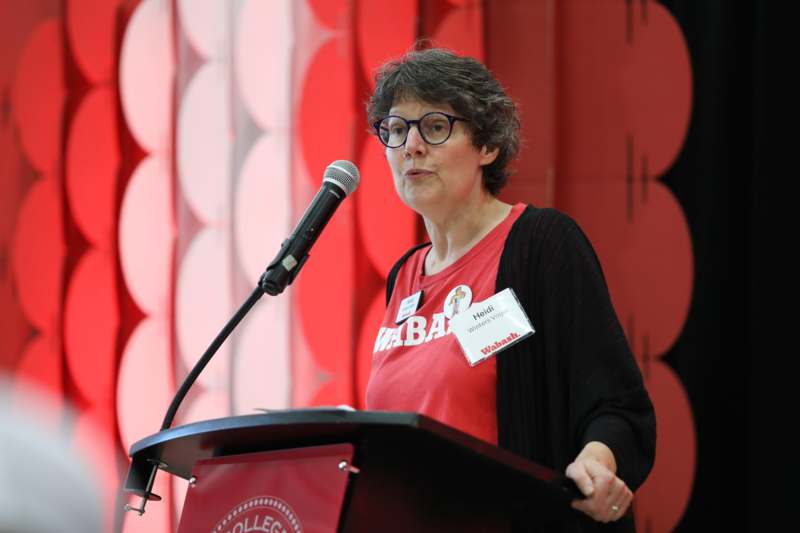 a woman standing at a podium with a microphone