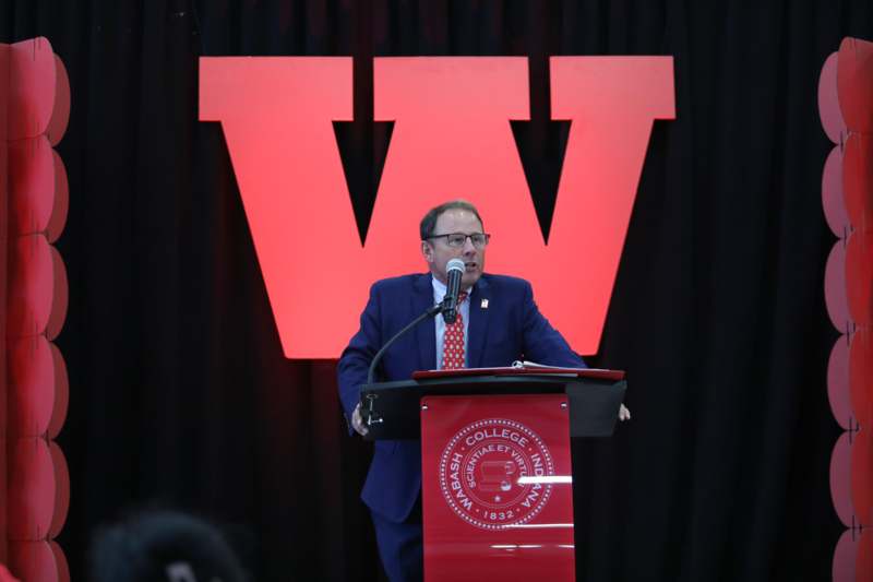 a man standing at a podium with a microphone