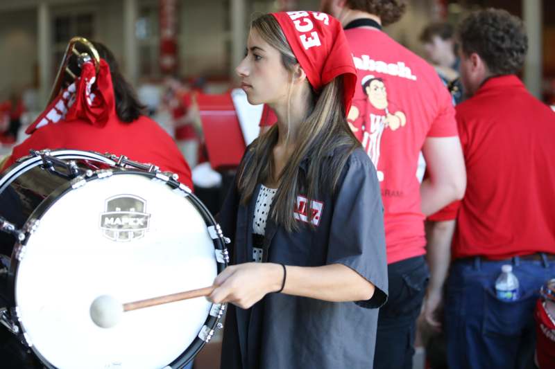 a woman playing a drum