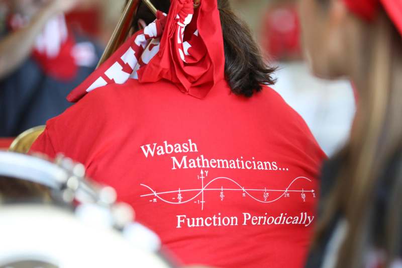 a person wearing a red shirt with writing on it