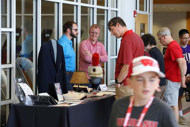 a group of people standing around a table