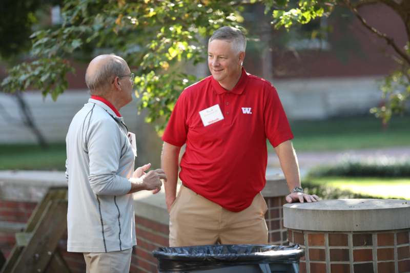 a man talking to another man