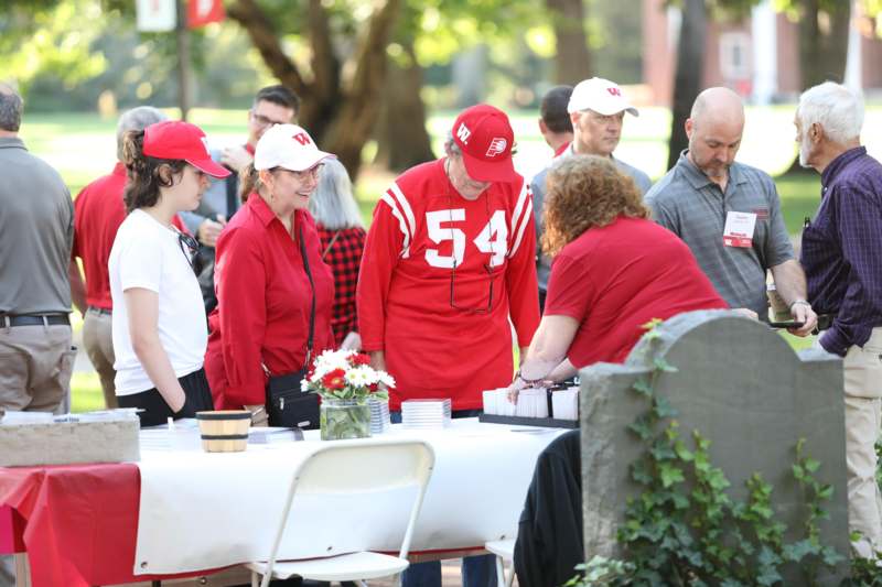 a group of people standing around a table