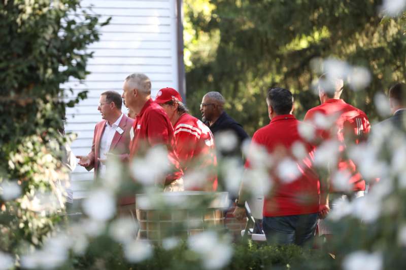 a group of men in red shirts