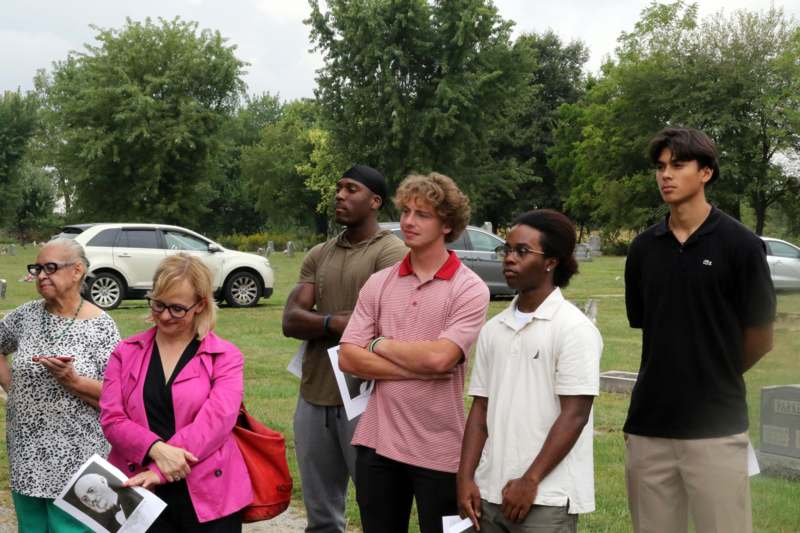 a group of people standing in a field