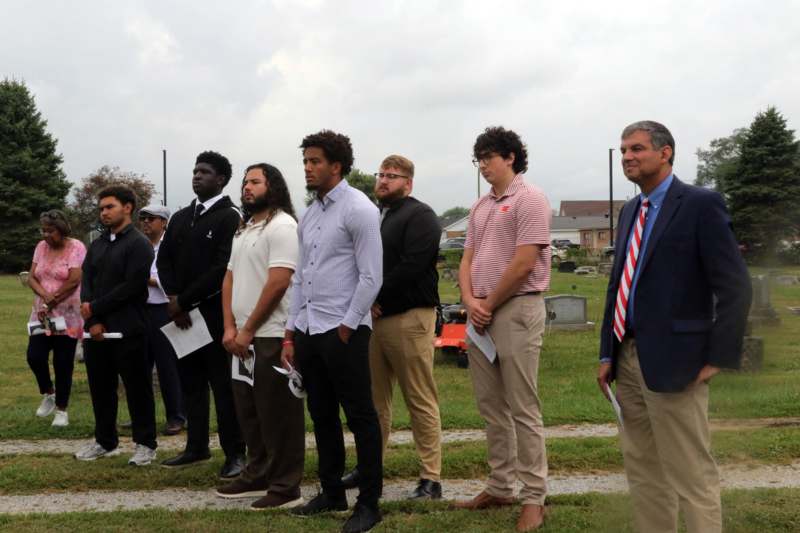 a group of men standing in a line