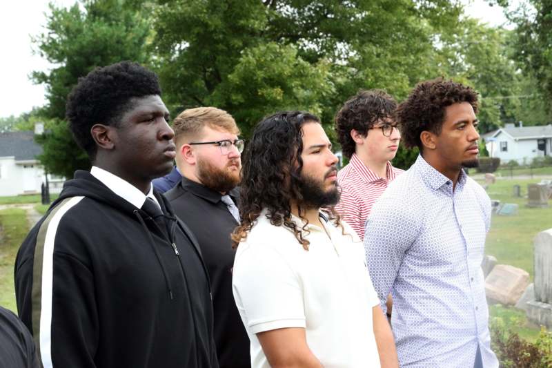 a group of men standing outside