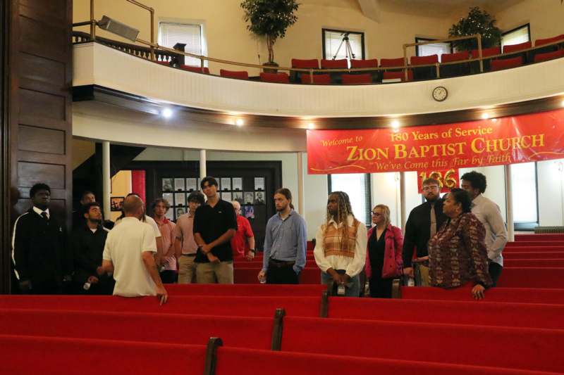 a group of people standing in a church