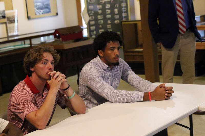 a group of men sitting at a table