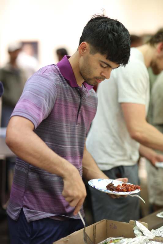 a man holding a plate of food