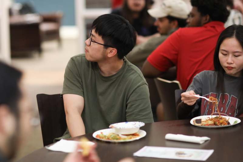 a man sitting at a table with food on it