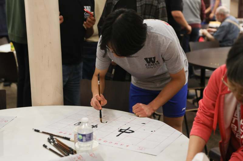 a person painting on a paper