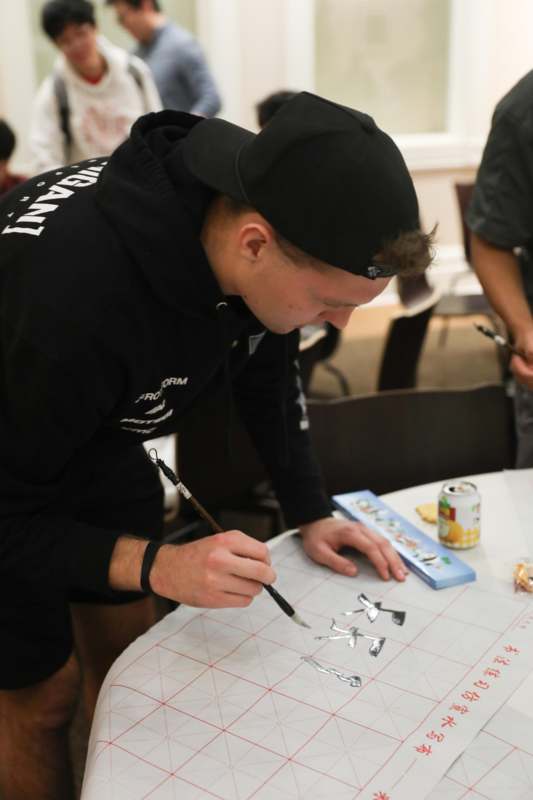 a man painting on a paper