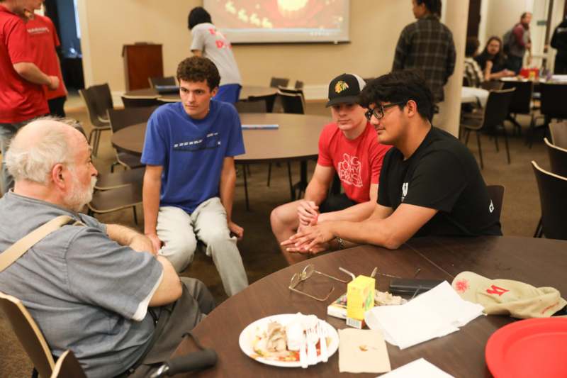 a group of people sitting around a table