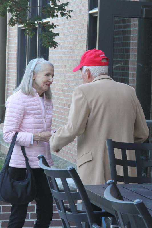 a man and woman standing outside a building