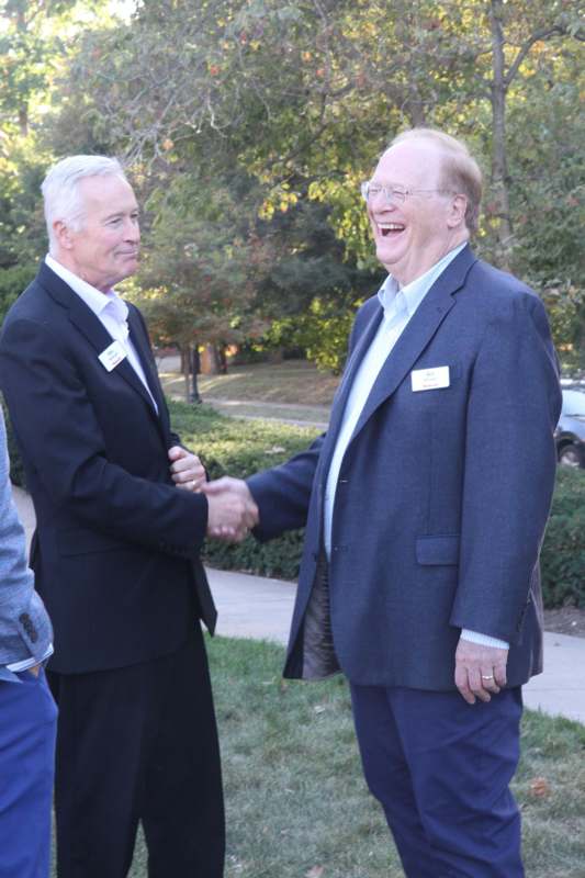 a man shaking hands with another man