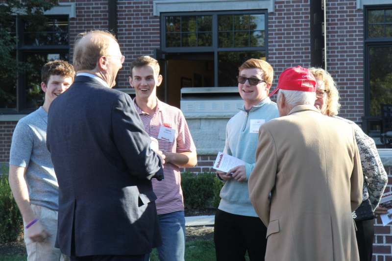 a group of people talking outside