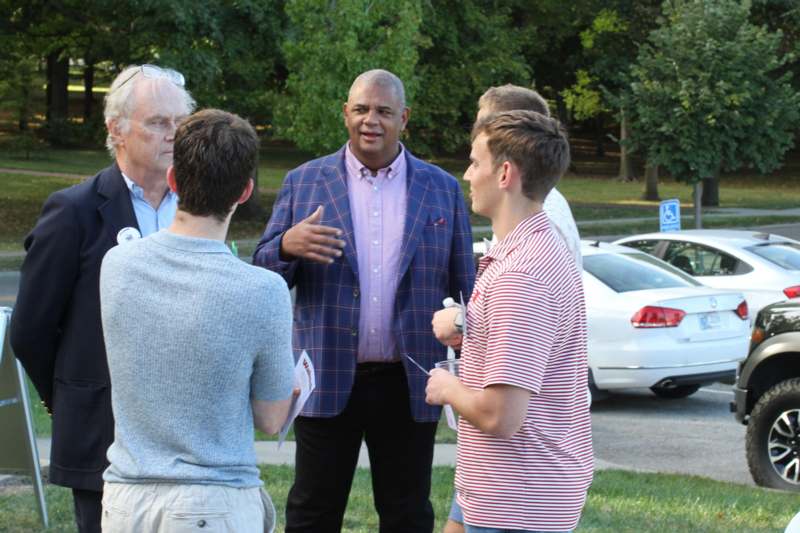 a man standing in a circle with other people around him