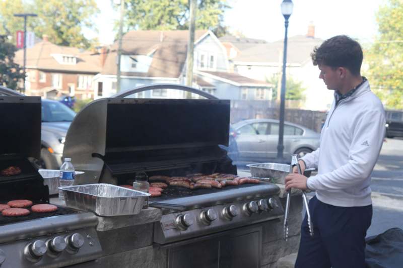a man cooking food on a grill