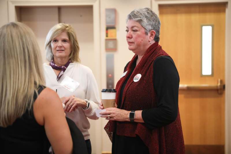 a group of women talking to each other