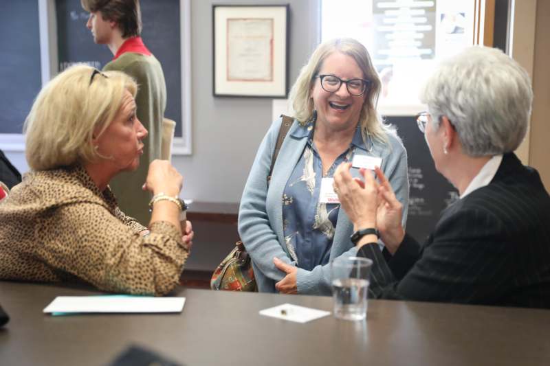 a group of women laughing at a table