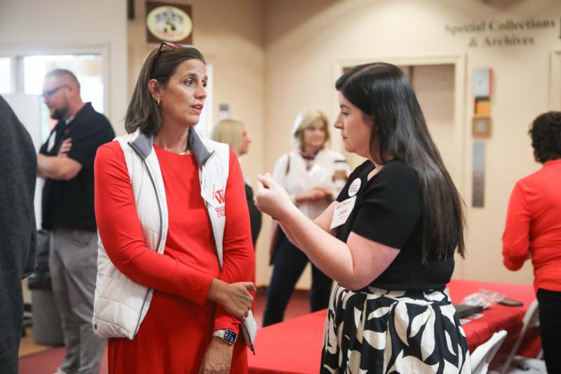 a woman talking to another woman
