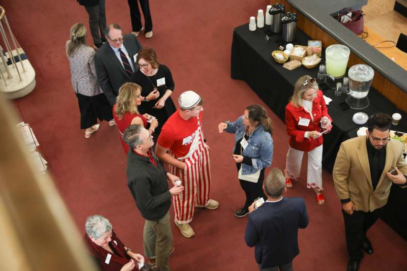 a group of people standing around a table