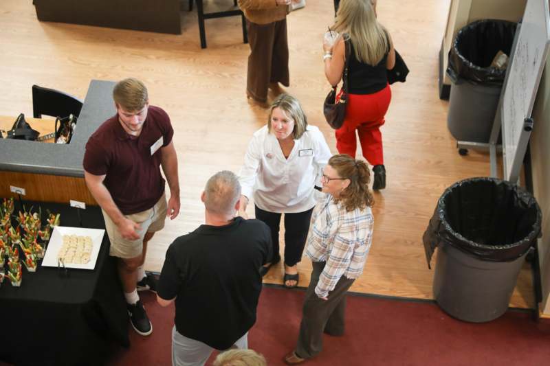 a group of people standing around a table
