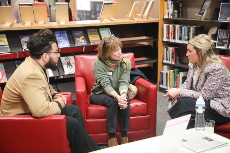 a group of people sitting in chairs in a library