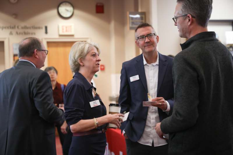a group of people talking in a room
