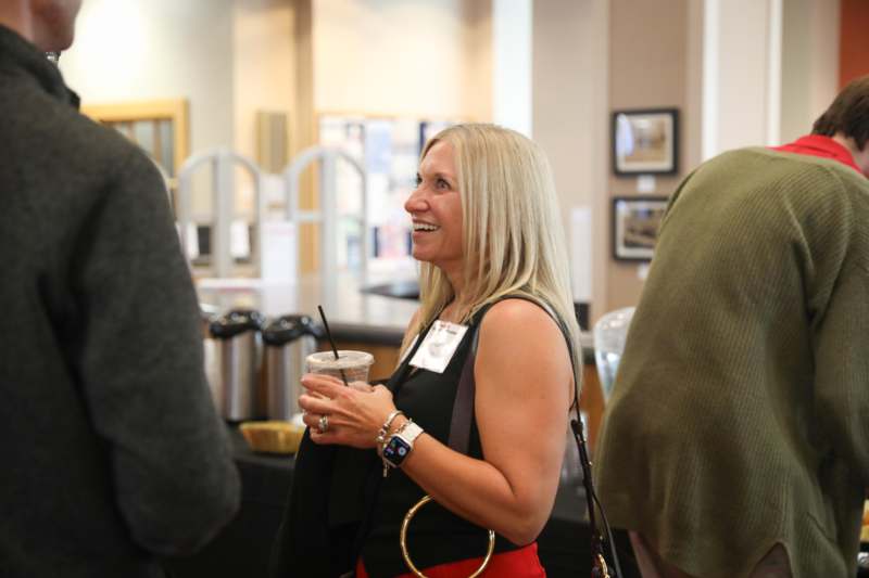 a woman holding a drink
