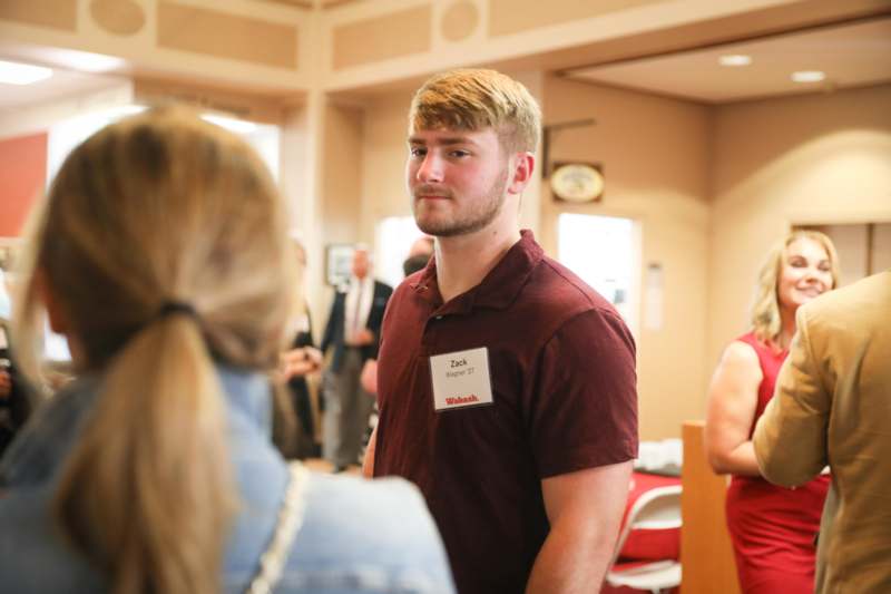 a man standing in a room with a woman