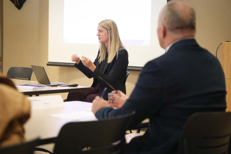 a woman giving a presentation to a man