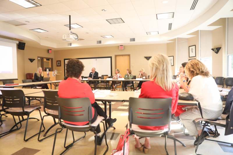 a group of people sitting at tables in a room