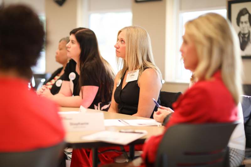 a group of women sitting at tables