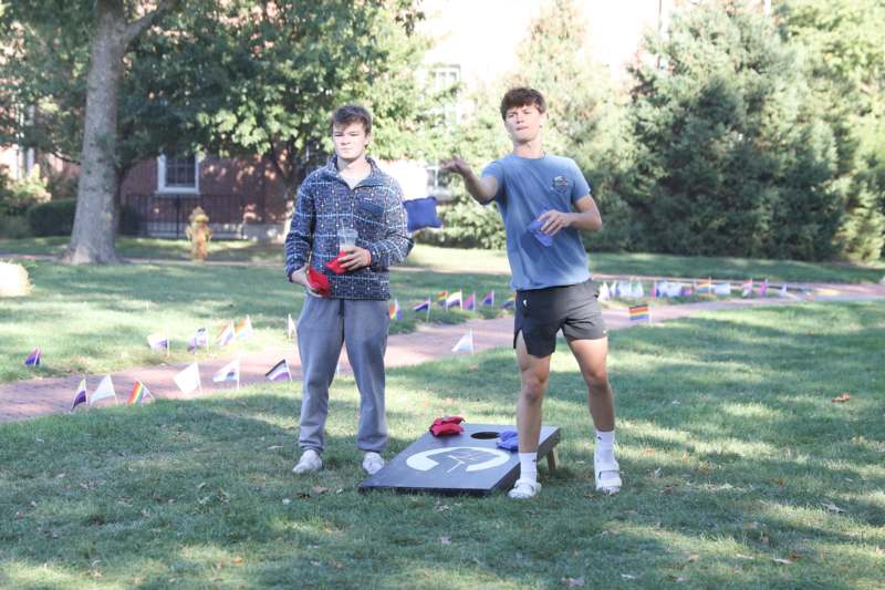 two men standing in a grassy area