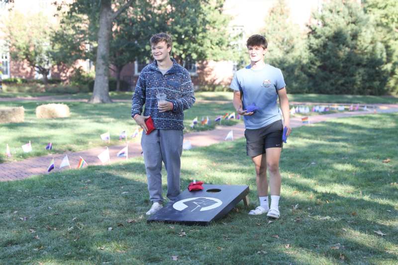 two men standing in a grassy area