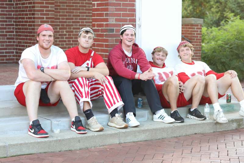a group of men sitting on steps