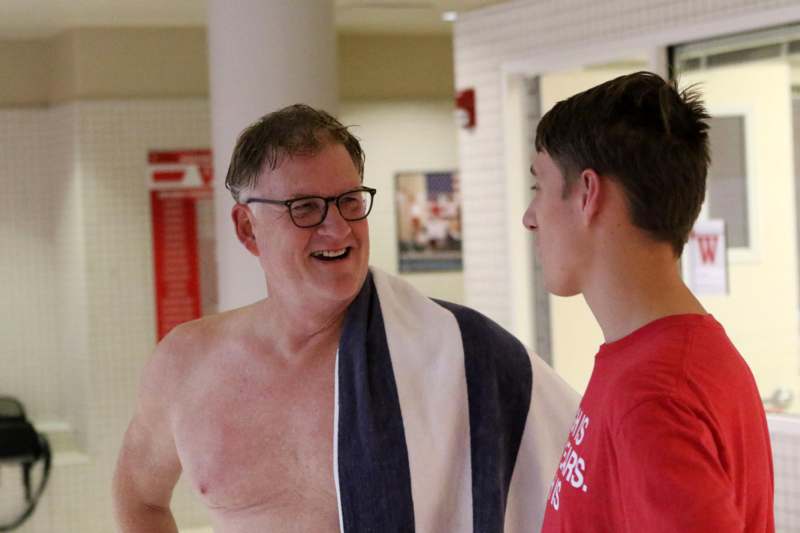 a man with a towel around his neck