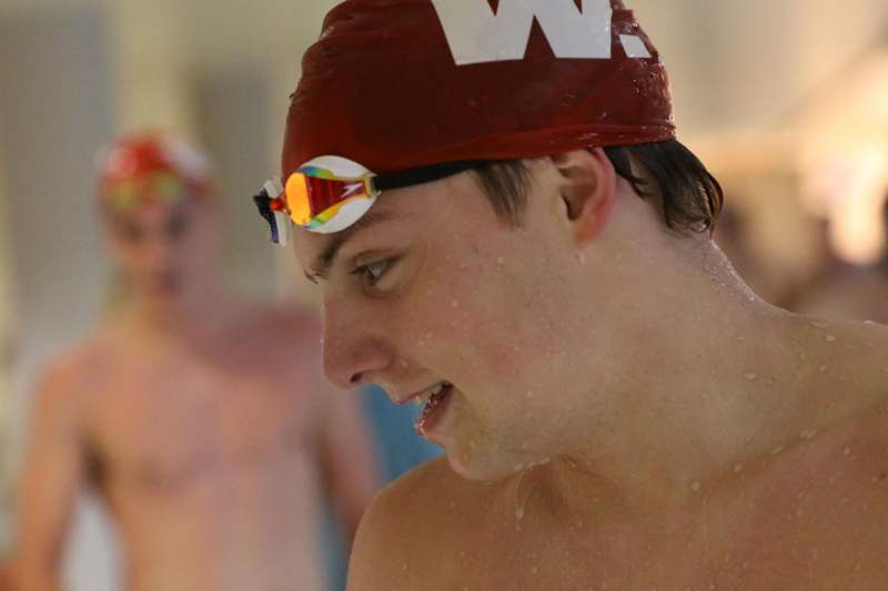 a man wearing a swim cap and goggles